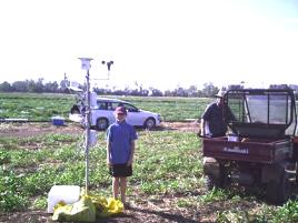 PhotoID:4042, Point Farm owner Ian Kennedy and daughter Hayley Kennedy by the newly set mobile weather station next to the melon experimental plot (photo with the permission of Ian Kennedy).