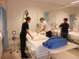 PhotoID:14492, Students learn how to correctly make a bed for the clinical environment. 