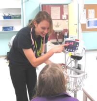 PhotoID:7735, First-year Nursing student Madeline Hamlin demonstrates blood pressure monitoring. PhotoID:7735, First-year Nursing student Madeline Hamlin demonstrates blood pressure monitoring.