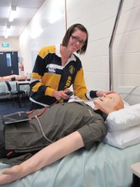 PhotoID:10660, Rebecca Howard with one of the Paramedic Science SimMan manikins