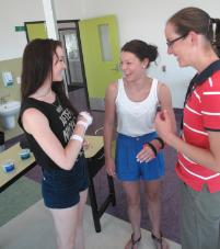 PhotoID:13495, Allied Health Clinic Occupational Therapist Jayne Moyle (right) shows Abby Grentell (left) and Lauren Rixon some of the tools of the profession