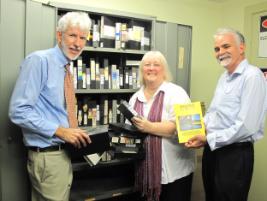 PhotoID:10414, L-R Ross Quinn, Christina Hunt and Professor Denis Cryle check the ABC videotapes have survived the latest floods