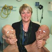 PhotoID:11861, Dr Kerry Reid-Searl with some of her character masks