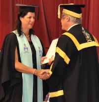 PhotoID:11970, Joanne Emmert crosses the stage at graduation