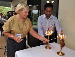 PhotoID:14047, Representing the Buddhist faith, Rhonda Shuker lights an oil lamp