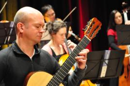 PhotoID:10869, Matthew Marshall complements a string orchestra with the beautiful sounds of the classical guitar.