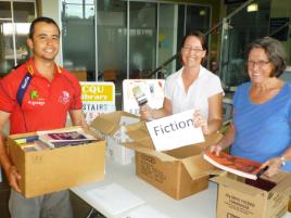 PhotoID:14582, Library Society committee members Pancho Garcia and Sally Dhu and volunteer Sue Turner are busy sorting through book donations ahead of the upcoming book sale in August. 