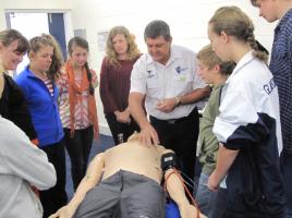 PhotoID:12670, Paramedic Science lecturer Daryl Holley shows Science Camp participants 'Sim Man'