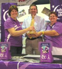 PhotoID:5087, Aurilea Augustine hands over the role of Relay for Life committee Chair to Ros Bedward with the help of Relay ambassador Corey Munson