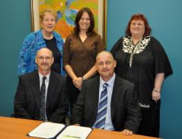 PhotoID:8618, Celebrating the collaboration with Hungary's Miskolc University: (back) Dianne Fletcher, Stephanie Crandall, Jennifer Kofoed, (front) Dr Patrick Keleher and Jansci John Mark. Dr Fae Martin (Director: Engineering and Physics UG Programs) was absent from the signing