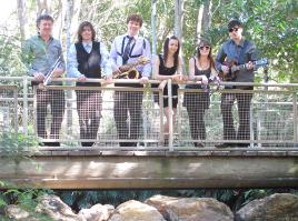 PhotoID:8928, Uni music students (left to right) Glenn Thomas, Michael Scriha, Luke Scott, Hannah Blomfield, Zoe Hadok-Quadrio and Shane Gibbons on a 'bridge over bubbling waters', preparing for their free riverside show on Sunday.