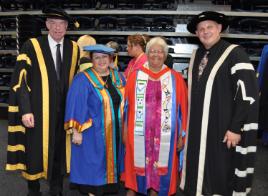 PhotoID:13208, Dr Judith Tatow (in red) is congratulated by L-R Deputy Chancellor Charles Ware,  Pro Vice-Chancellor (Indigenous Engagement) Professor Bronwyn Fredericks and Vice-Chancellor Professor Scott Bowman