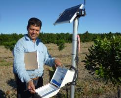 PhotoID:11664, Dr Surya Bhattarai inspects part of his innovative irrigation system