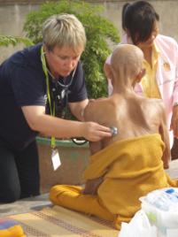 PhotoID:6747, Dr Reid-Searl treating a Buddhist monk