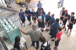 PhotoID:8587, Centre for Plant and Water Science research technician Brock McDonald explains the process of aquaponics