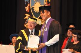PhotoID:14991, Chancellor Rennie Fritschy confers the honorary Master of Sports Science degree on Geoff Huegill
