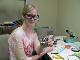 PhotoID:4895, Danica Berry with the electrical circuit she built while at PELM