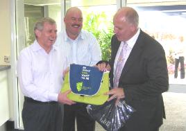 PhotoID:9254, Mr Crean laughs as he accepts a special 'Simon Says' version of CQUni's polo shirt, while ALP candidate for Dawson Mike Brunker watches on