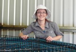 PhotoID:13537, Victoria Hammer inspects the aquaculture tank used for fattening crabs