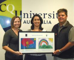 PhotoID:9693, The Smith Family's Wendy Gernhoefer (centre) presented CQUniversity's Michelle Hufton and Pro Vice-Chancellor Dr Pierre Viljoen with a framed print in Mackay.