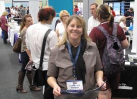 PhotoID:11209, Carissa Stark from Capricorn Enterprise checks the schedule of events for the Capricorn Careers Expo