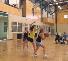 PhotoID:8791, Yellow-shirted Sarah Kale (Underdogs) battles with Anna Reeve from A-team during the basketball