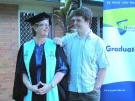 PhotoID:10520, Karen prepares for graduation, with some support from son Ethan