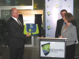 PhotoID:8926, Deputy PM Julia Gillard accepts a 'be what you want to be' bag from Vice-Chancellor Professor Scott Bowman, amid leadership chatter in the media