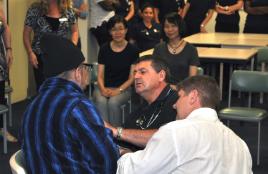 PhotoID:14288, The 'masked educator' (aka Prof Kerry Reid-Searl) is checked by Paramedic Science academics Darryl Holley and Anthony Weber 