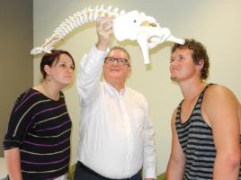 PhotoID:11986, Professor Phillip Ebrall gives new chiropractic students Melissa Pope (right) and Theunis Nieuwoudt (left) a taste of what they will learn this year. 