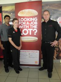 PhotoID:13549,  Taylor Smith (centre) is completing a Certificate II in Retail through Hungry Jacks thanks to the support of her supervisor Prabhot Grewal (left) and manager Marty Mason (right)