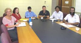 PhotoID:9985, Members of a reference group discuss the value of 'micro-credit': L-R researchers Vicki Pascoe, Kylie Radel and Dr Rakesh Gupta, with John Anderson (Pi-Cats Ptd Ltd), Thalep Ahmat (Qld Govt Indigenous Enterprise Development Officer); and Bob Muir from Rockhampton Regional Council