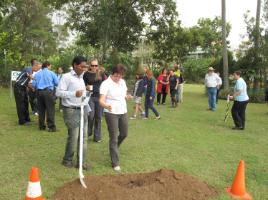 PhotoID:13253, CQUniversity Multi-Faith Chaplain Shaji Joseph watches on as staff member Robyn Bailey joins others helping to 'water the ground', as part of a ceremony to bless the work site. Dozens of students and staff from many different faiths helped to water the ground before construction.