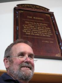 PhotoID:8228, Tony Gubbins reminisces about the time he wrote the Capricornia College's Blessing which now hangs in the dining hall of the residential college.