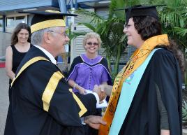 PhotoID:9622, Chancellor Rennie Fritschy presents a Nulloo Yumbah sash to Indigenous graduate Rachel Carte. Rachel graduated with a Bachelor of Environmental Science