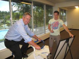 PhotoID:7743, Mayor Brad Carter tries out some of the new Exercise and Sports Sciences laboratory gear overlooking the pool, with help from PhD student Aaron Scanlan