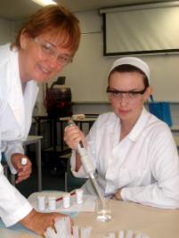 PhotoID:5291, CQU Mackay science lecturer Delma Clifton assists Townsville student Holly-Maree Norman of Ryan Catholic College, this week at CQU Mackay Siemens Science experience