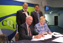 PhotoID:7522, Professor Angela Delves and GAPDL Board Chairman Colin Burke sign the MOU in the presence of GAPDL CEO Glenn Churchill and Gladstone Campus Head Dr Pierre Viljoen