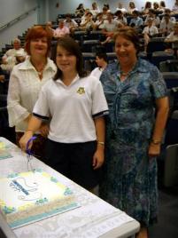 PhotoID:5201, A Bundaberg State High student cuts the TAP celebrations cake with Head of Academic Learning Support Karen Seary and BSHS Principal Raylene Fysch