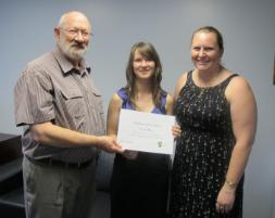 PhotoID:11997, Recipient Carissa Miller (centre) is congratulated by Head of Campus Professor Phillip Clift and Marketing Director Susanne Schick