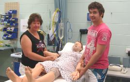 PhotoID:8628, Second-year Nursing students Kathaleen Ball and Michael Middleton, with Nursing Annie in the simulation lab