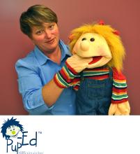 PhotoID:11873, Kerry with one of the puppet resources and the new educational resource logo