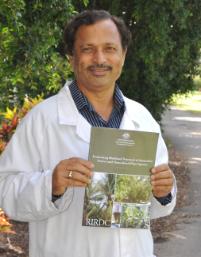 PhotoID:10776, Associate Professor Nanjappa Ashwath with a copy of his new publication