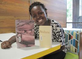 PhotoID:11567, CQUni Library staff member Joyce Halwenge displays two of the books on the Queensland shortlist, 'Journey to the Stone Country' and 'Brisbane'