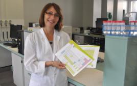 PhotoID:10600, Science lecturer Leanne Voss shows off the new periodic tables produced for high school students.