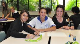 PhotoID:11081, Mt Morgan State High School student Mercury Mowen and Gladstone State High School students Renee Scott and Chantelle Giles enjoy making a DC motor during CQUniversity's Science Experience.