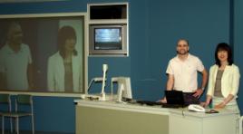 PhotoID:5165, CQU's Chris Lucas shows visiting professor from Japan Associate Professor Kanaho Matsuda CQU's videoconferencing facilities.