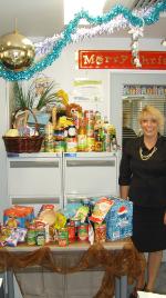 PhotoID:8147, Suellen Thomas, Bundaberg Campus Receptionist, with the donation for the Salvos Christmas Appeal