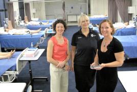 PhotoID:13640, Beverley Lay (centre) is congratulated by MP Kirsten Livermore (left) and CQUniversity's Centre for Professional Health Director Deborah Austen after re-registering to become a nurse