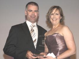 PhotoID:8095, Barbara receives her trophy from a representative of category sponsor Vodafone in Brisbane. Photo courtesy of Kirkland Photography.